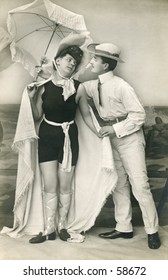 Vintage Photo, Circa 1900 Of A Man And Woman With A Beach Umbrella