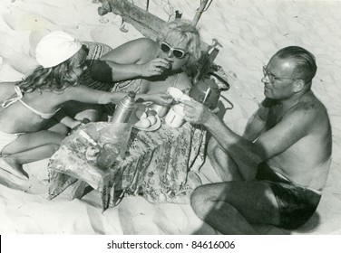 Vintage Photo Of Family Having Lunch On Beach (fifties)