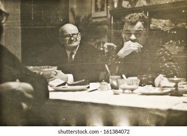 Vintage Photo Of Father And Son During Family Dinner (sixties)