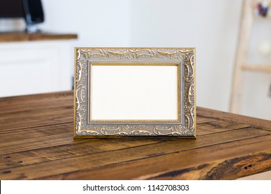 Vintage Photo Frame On Wooden Table