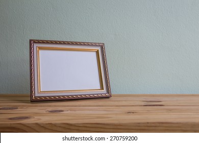 Vintage Photo Frame On Wooden Table Over Grunge Background, Still Life Style