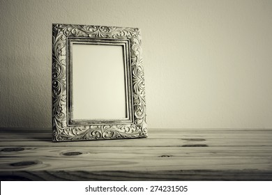 Vintage Photo Frame On Wooden Table Over Grunge Background, Still Life Style