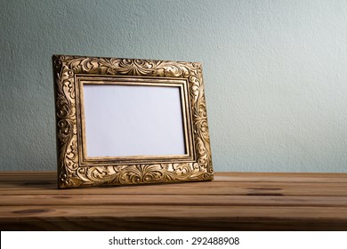 Vintage Photo Frame On Wooden Table Over Grunge Background