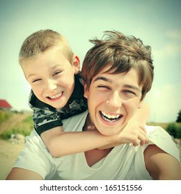 Vintage Photo Of Happy Teenager And Kid Outdoor