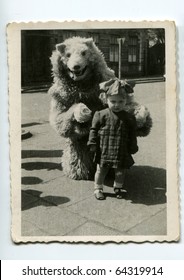 Vintage photo of little girl with fake bear