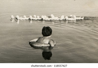 Vintage photo of little girl swimming with lifebuoy (fifties)