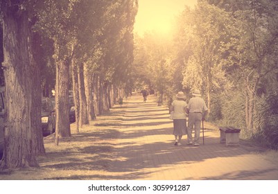 Vintage Photo Of Old Couple Walking In The Park A Sunny Day
