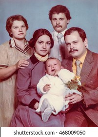 Vintage photo of parents, God parents and a baby boy (Christening), early 1980's