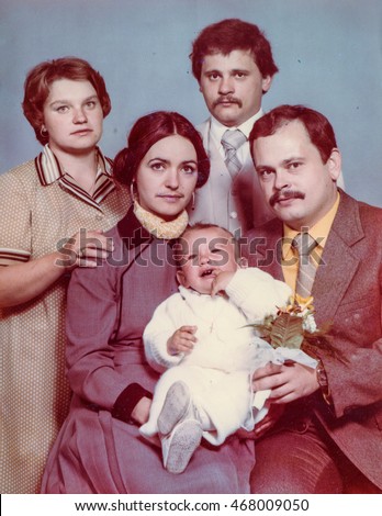 Vintage photo of parents, God parents and a baby boy (Christening), early 1980's