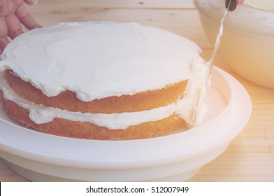 Vintage Photo Of Putting Butter  Cream Cake By Hand Using Spatula