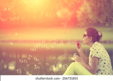 Vintage photo of soap bubble blower young woman - Powered by Shutterstock