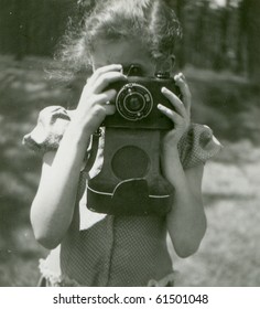 Vintage photo of young girl with camera (fifties)
