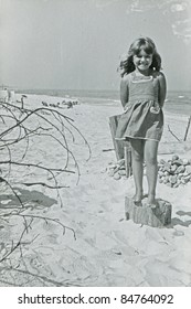 Vintage photo of young girl on beach (fifties)