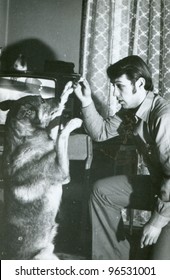 Vintage Photo Of Young Man Training A Dog (sixties)