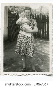 Vintage Photo Of Young Mother With Her Baby (forties)