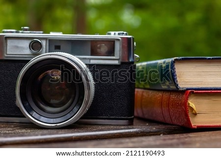 Vintage photocamera and old books 