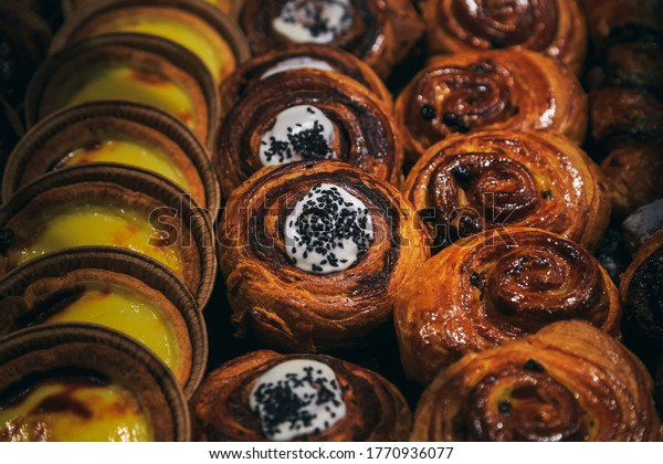 Vintage photography style of cream pastry puff\
dessert in row, selected\
focus.