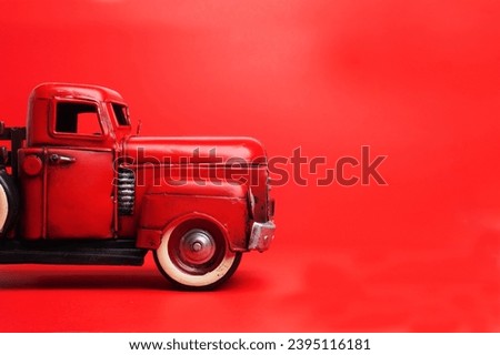 Vintage pickup truck from the 50s, Ford on  red background. toy or model. Space for trext.