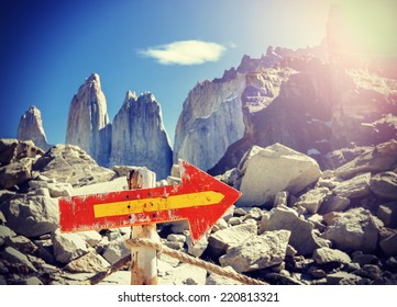 Vintage Picture Of Wooden Direction Sign Post On A Mountain Path, Torres Del Paine National Park, Chile.