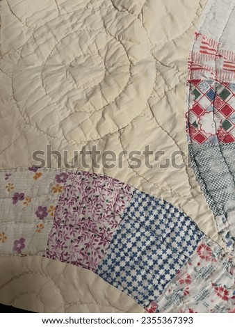 Vintage pieced patchwork quilt with double wedding ring pattern made with feed sack fabric and hand stitched