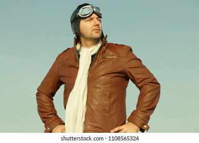 Vintage Pilot With Leather Cap, Scarf And Aviator Glasses  - Portrait Of A Man In Historical Pilot Clothing