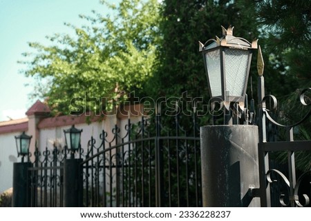 Vintage plafond of a street lamp on the fence. Urban street lighting. Imagine de stoc © 