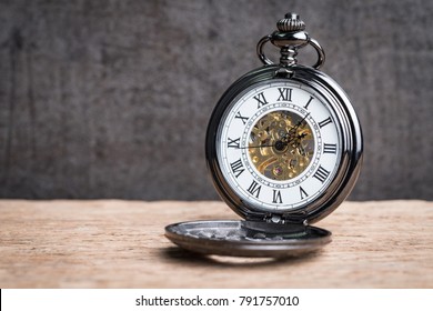 Vintage pocket mechanic watch on wooden table using as time symbol or business deadline concept. - Powered by Shutterstock