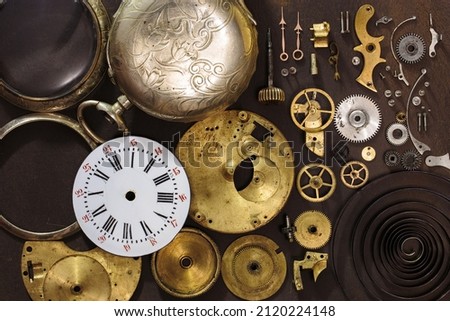Vintage pocket watch clockwork mechanism parts. Detail of clock parts for restoration.