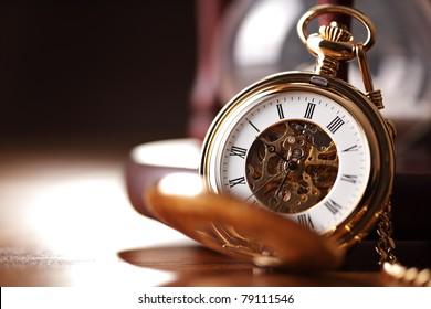 Vintage pocket watch and hour glass or sand timer, symbols of time with copy space