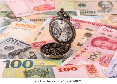 Vintage pocket watch and many banknotes of various countries of various denominations - Powered by Shutterstock