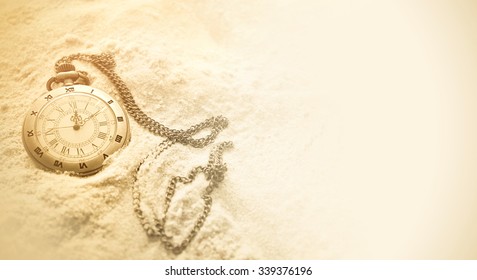vintage pocket watch on sand - Powered by Shutterstock