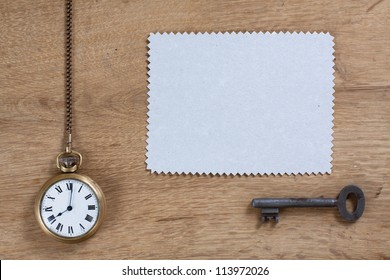 Vintage Pocket Watch, Paper Frame And Rusty Key On Wood