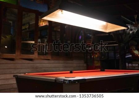 Vintage pool table in night club, pool snooker billiard concept background.