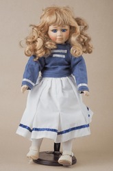 Vintage Porcelain Doll Vintage Porcelain Doll Girl With Blue Eyes Blonde With Loose Curly Bare Hair In A Blue Blouse With Two White Horizontal Stripes