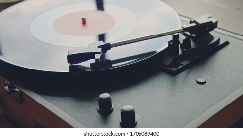 Vintage Portable Record Player Playing Vynil Record On Blurred Background