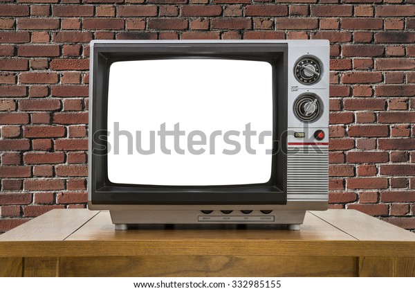 Vintage portable television with red brick wall\
and cut out screen.