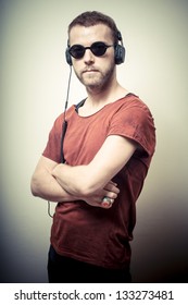 Vintage Portrait Of Fashion Guy With Headphones And Sunglasses On Gray Background