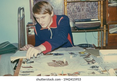 Vintage  Portrait Of Happy And Young Soviet Student Playing Popular Table Game In Dniepropersovsk State Univercity  Campus Room, USSR, Circa 1980