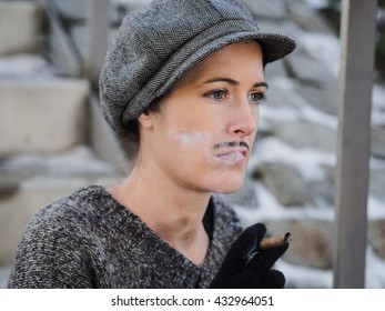 Vintage portrait of a serious woman disguised as a man sitting on the stairs smoking a cigar - Powered by Shutterstock