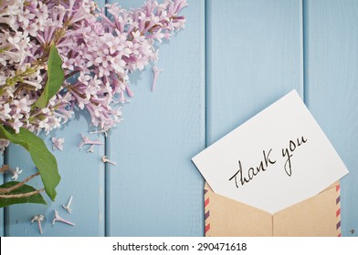 vintage postage envelope with card thank you and beautiful summer blooming bouquet of lilac
