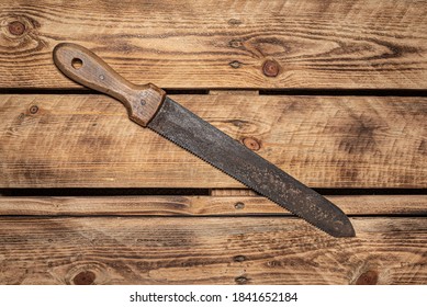 Vintage Pruning Hand Saw And Slasher, Gardening Hand Tool Isolated On Natural Wooden Plank Background. Old Garden Tool.