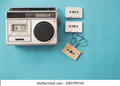 vintage radio and cassette player on blue background, flat lay, top view. retro technology