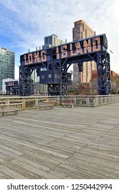 Vintage Railroad Gantries and Long Island sign with skyscrapers and apartment buildings in background, Long Island City, New York