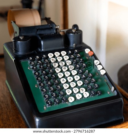 Vintage receipt printer machine for typing on long paper. Old number typewriter on the desk