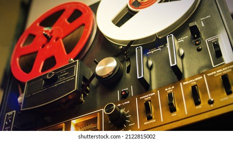 Vintage recording music concept with a close up shot of a reel to reel tape. Low angle, perspective shot. Selective focus