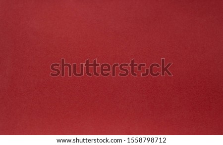 A vintage red background with a crisscross mesh pattern and grunge stains