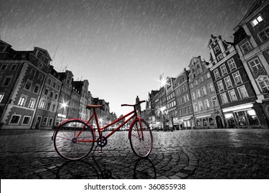 Vintage red bike on cobblestone historic old town in rain. Color in black and white. The market square at night. Wroclaw, Poland. - Powered by Shutterstock