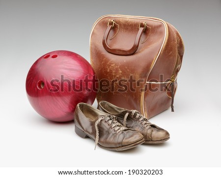 Vintage Red Bowling Ball, Weathered Leather Bag and Brown Shoes Isolated on White