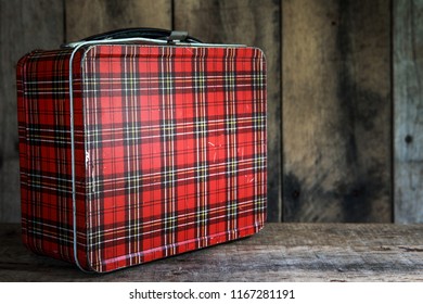 Vintage Red Metal Lunchbox On A Wooden Background