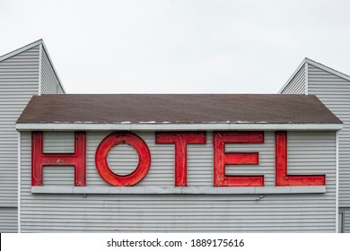 Vintage Red Neon Hotel Sign Unlit Broken Neon Tubes During The Day Time.